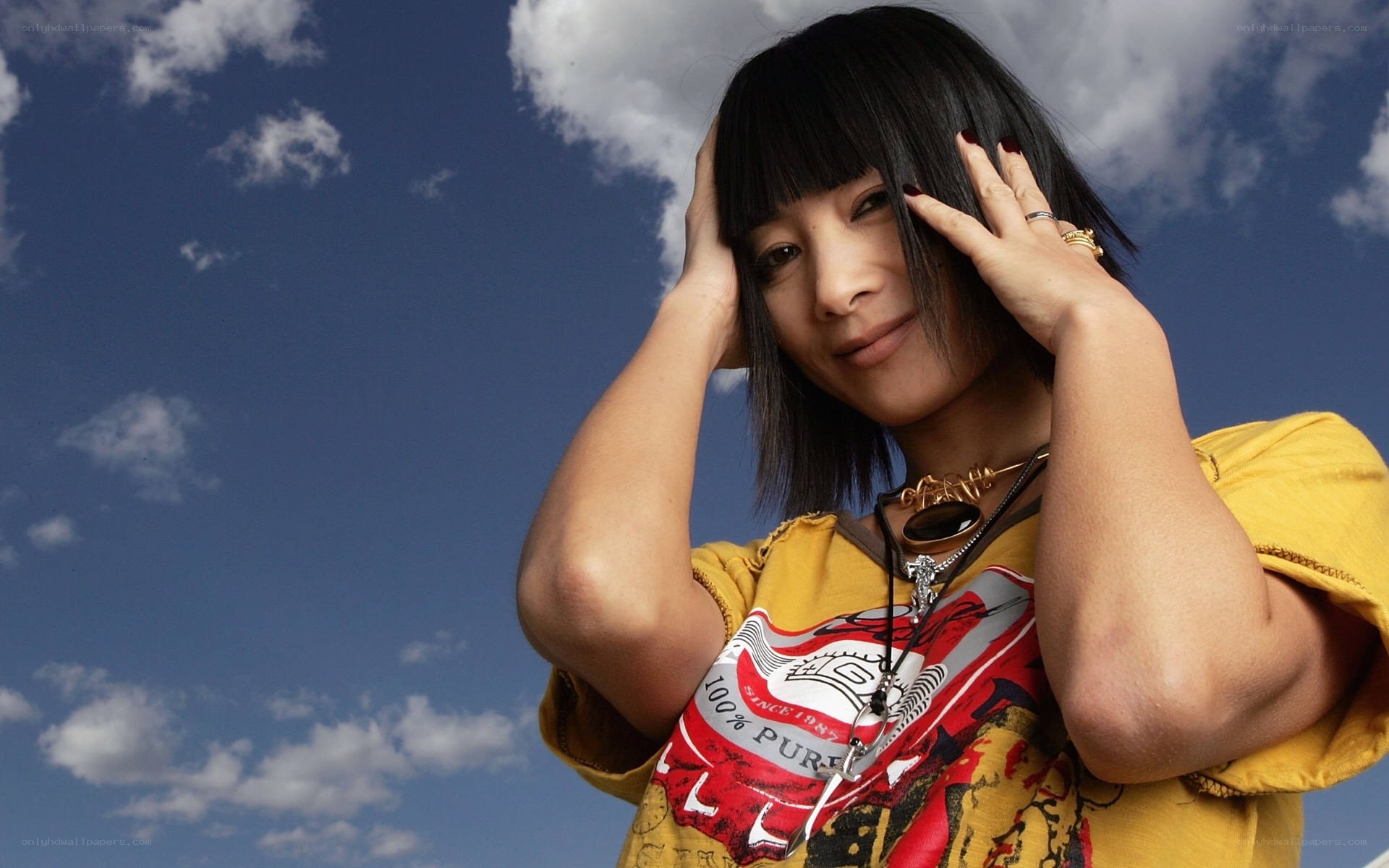 woman with black hair against blue sky