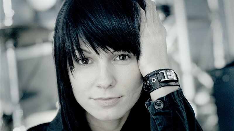 woman with black hair and leather bracelet