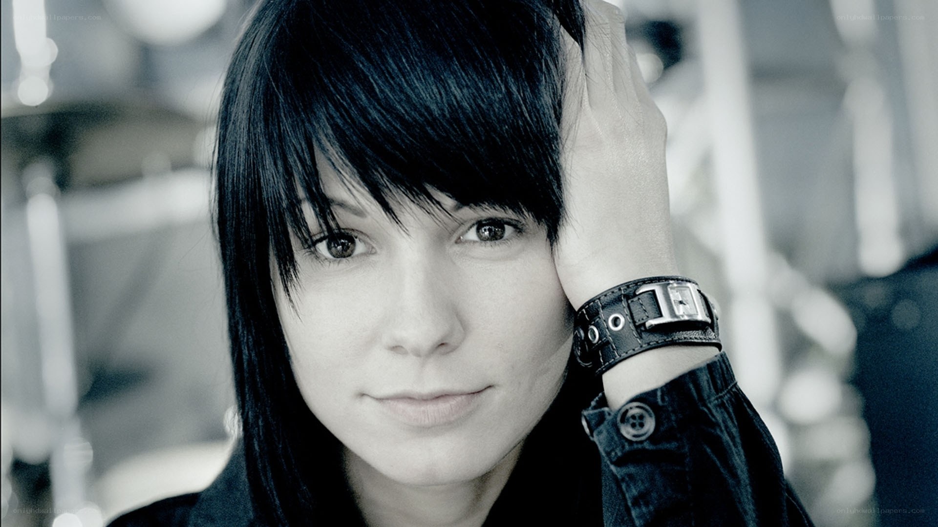 woman with black hair and leather bracelet