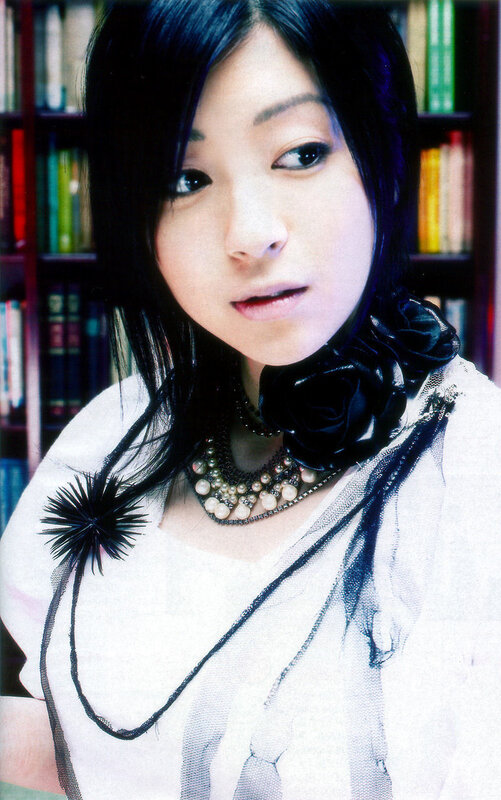woman with black hair and necklace