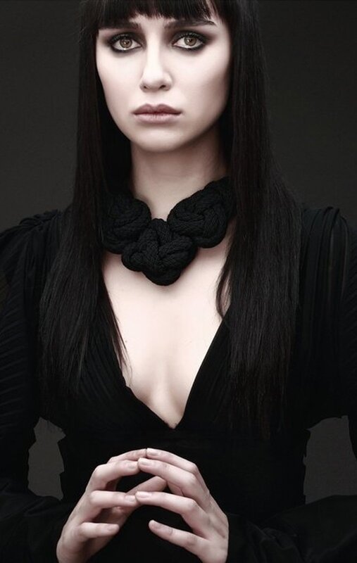 woman with black hair and necklace