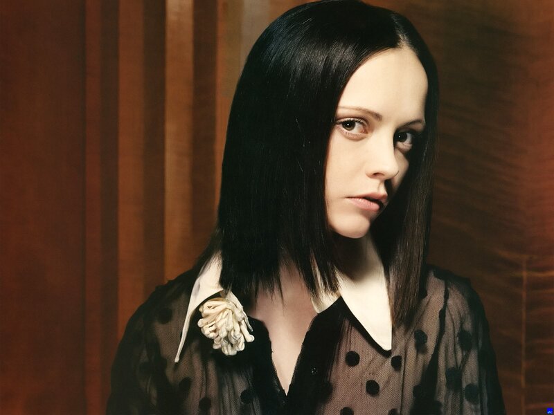 woman with black hair and polka dot shirt