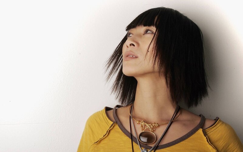 woman with black hair and yellow shirt