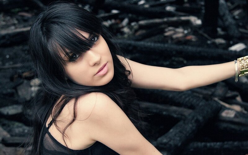 woman with black hair in dark setting