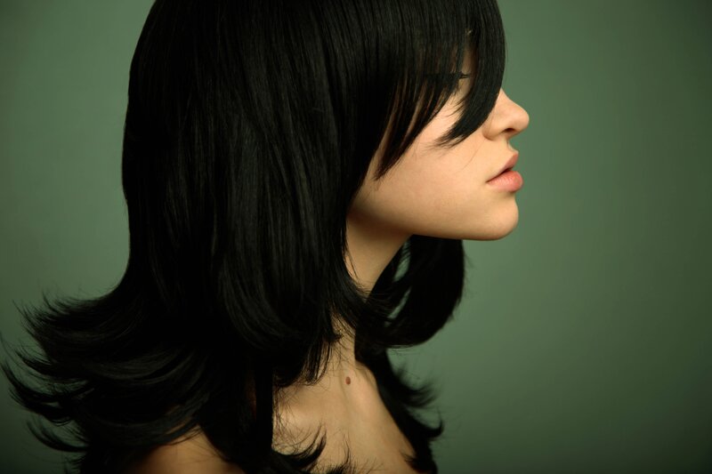woman with black hair in profile