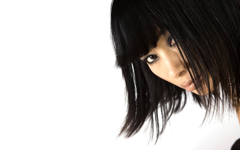 woman with black hair looking down