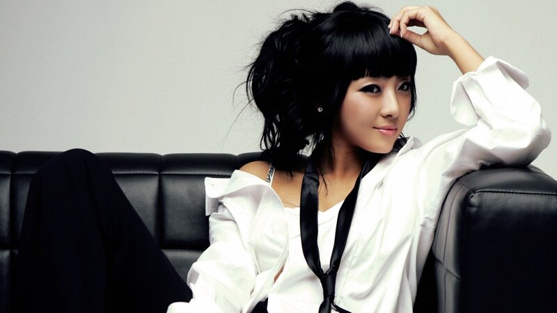 Woman with Black Hair — Relaxed, Photograph, Black Couch