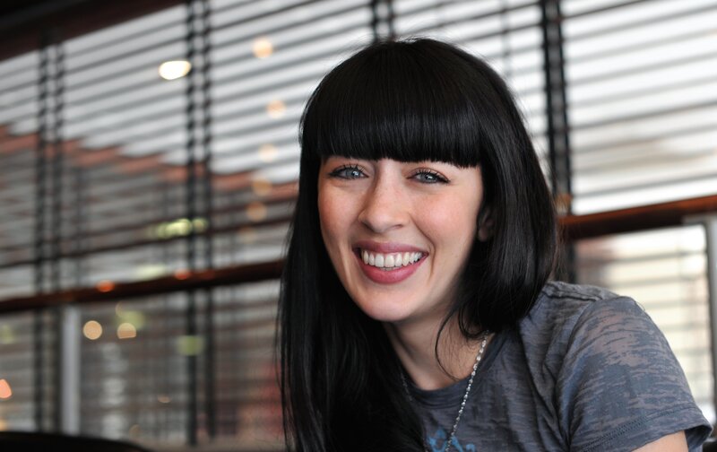 woman with black hair smiling