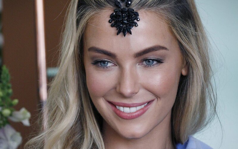 woman with black headpiece smiling