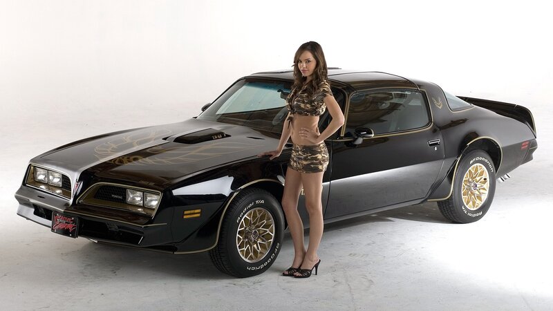 Woman with black muscle car