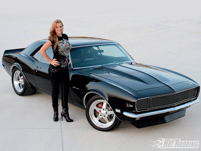 woman with black muscle car