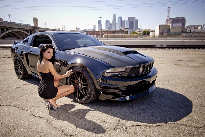 woman with black mustang car