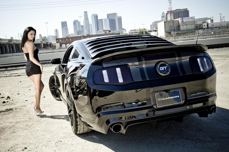 woman with black mustang car