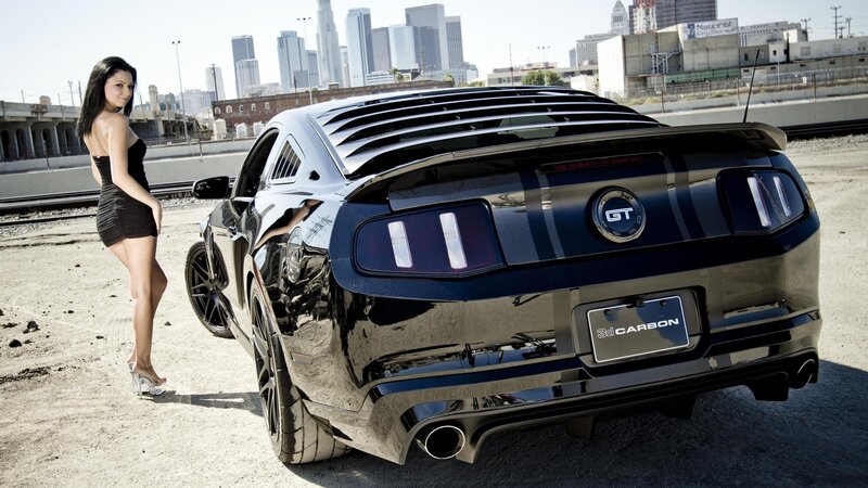 woman with black mustang car