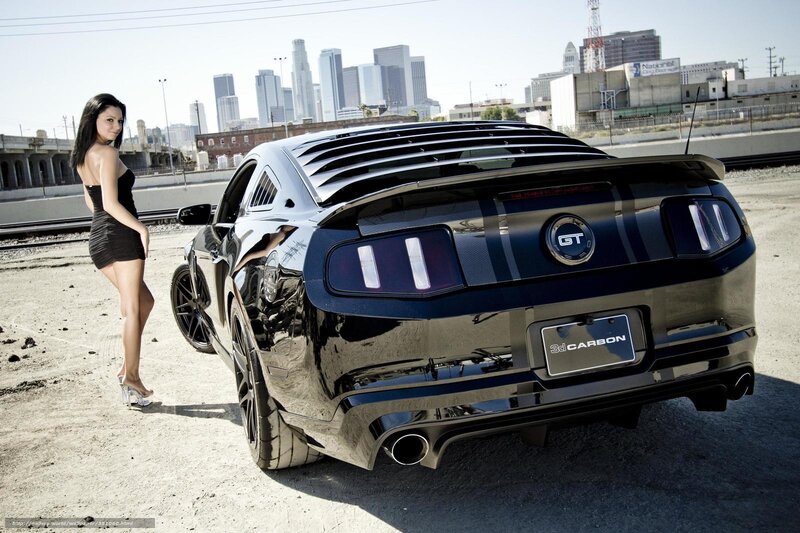 woman with black mustang car