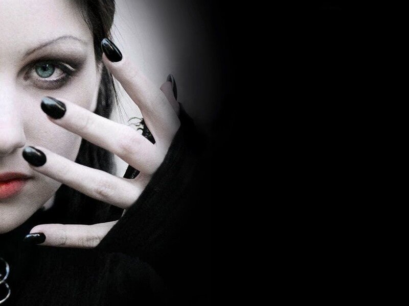 woman with black nails and dark makeup