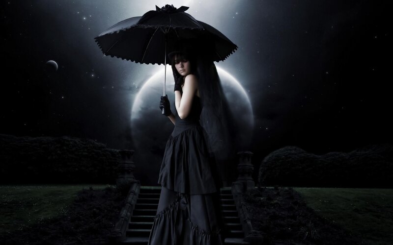 woman with black umbrella at night