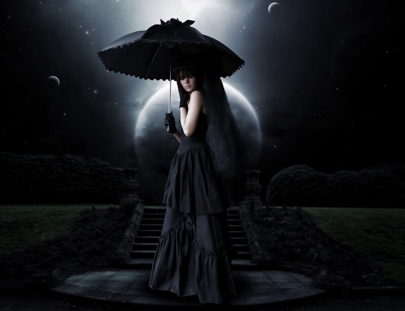 woman with black umbrella at night