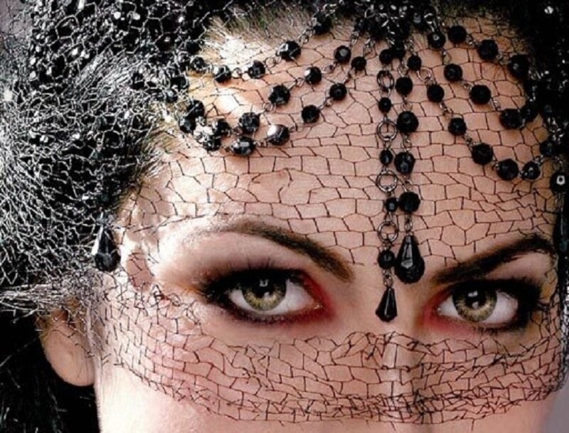 woman with black veil and beads