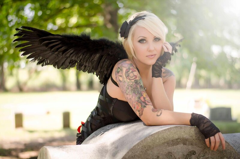 woman with black wings in cemetery