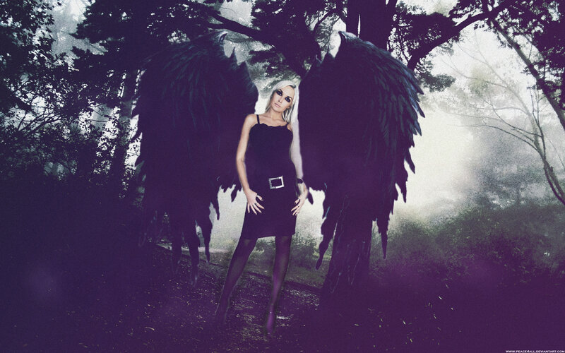 woman with black wings in forest