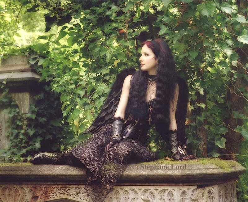 woman with black wings in garden