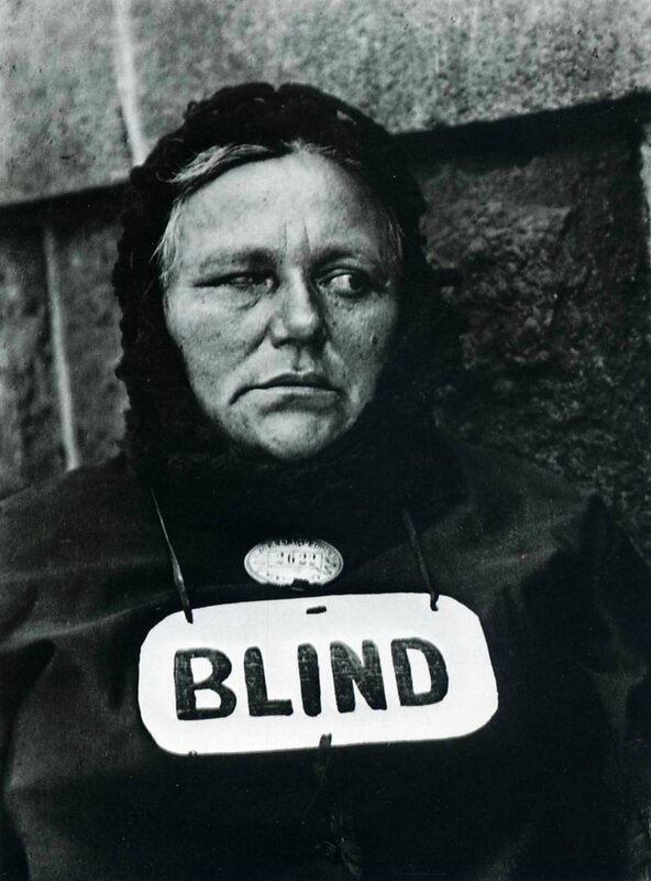 Woman with 'BLIND' sign