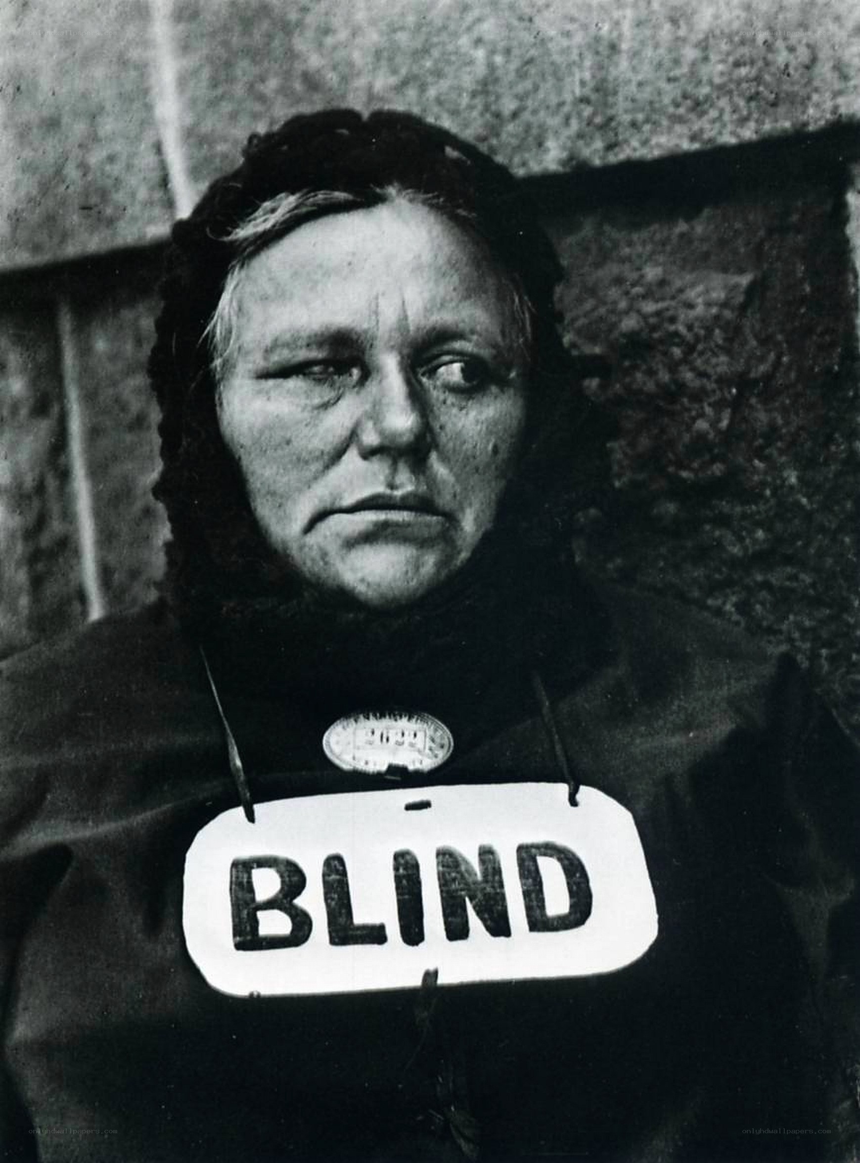 Woman with 'BLIND' sign