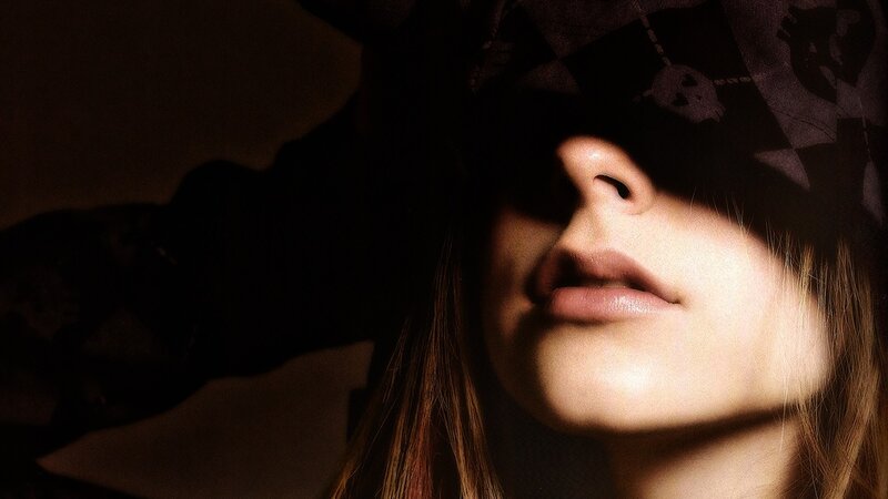 woman with blindfold in dim light