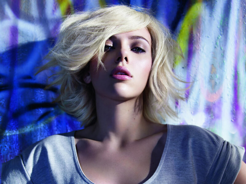woman with blonde hair against colorful wall