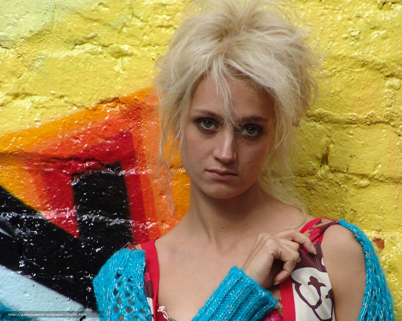 woman with blonde hair against graffiti wall