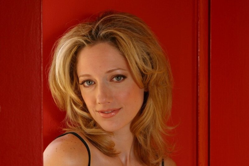 woman with blonde hair against red wall