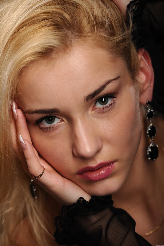 woman with blonde hair and black earrings