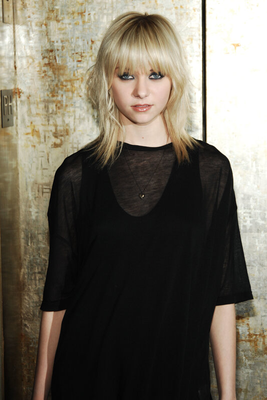 woman with blonde hair and black top