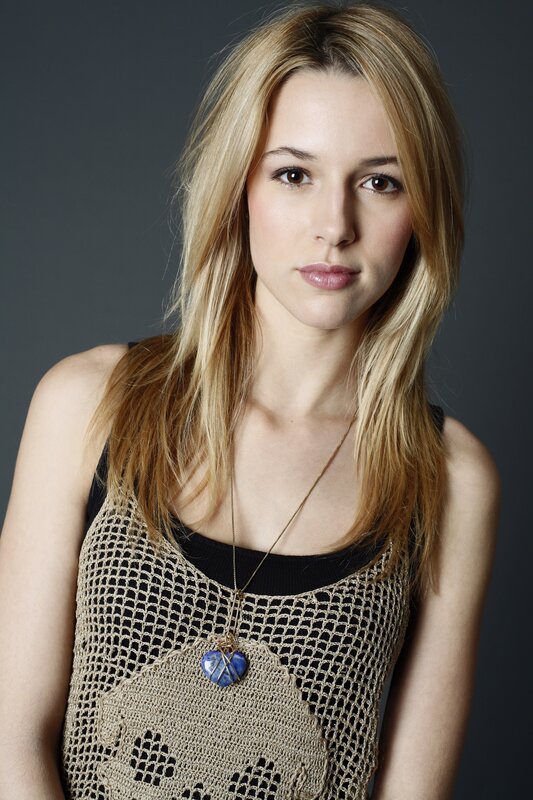 woman with blonde hair and blue pendant
