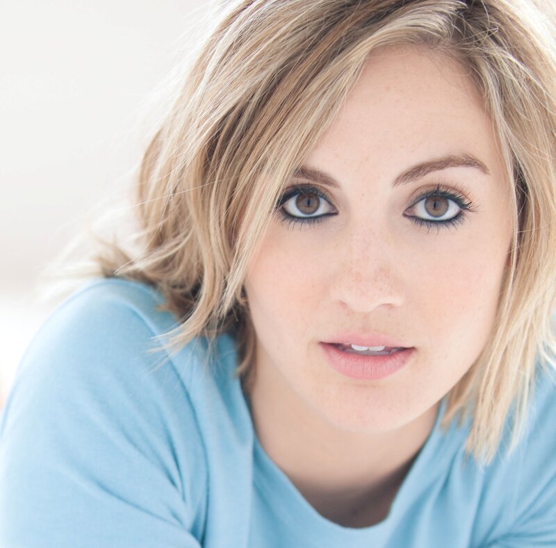 woman with blonde hair and blue shirt