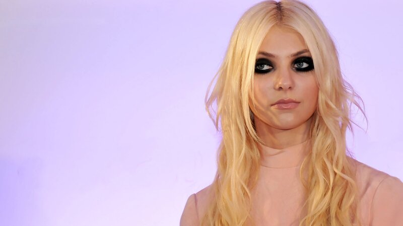 woman with blonde hair and dark makeup