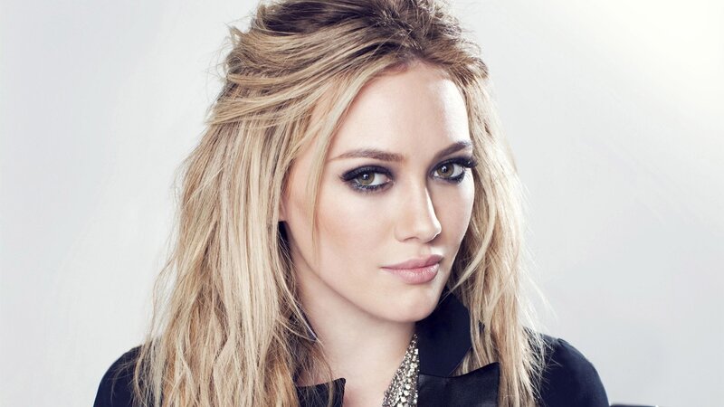 woman with blonde hair and dark makeup