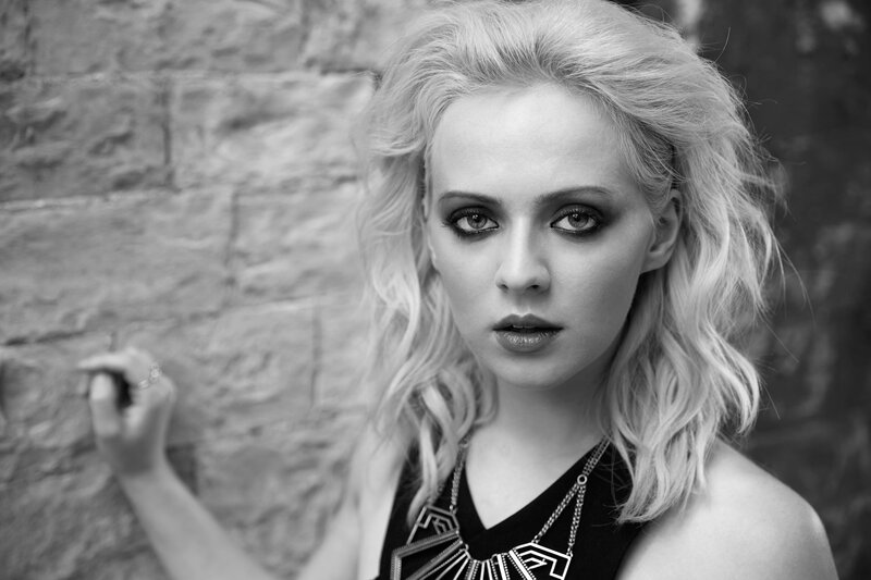 woman with blonde hair and dark makeup