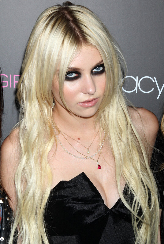 woman with blonde hair and dark makeup