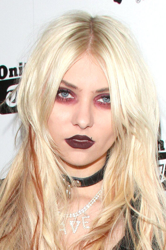woman with blonde hair and dark makeup