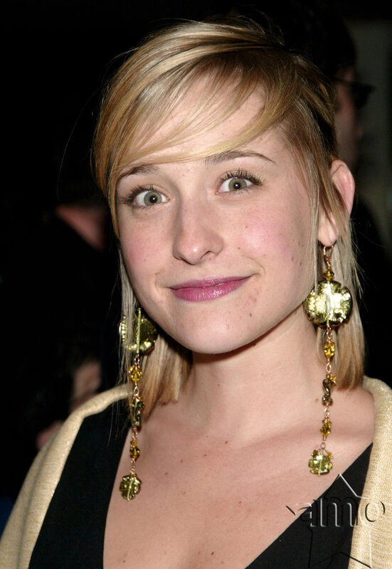 woman with blonde hair and earrings