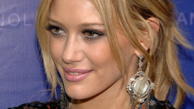 woman with blonde hair and earrings