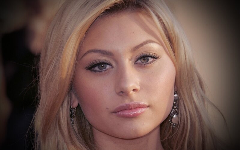 woman with blonde hair and earrings