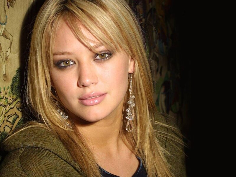 woman with blonde hair and earrings