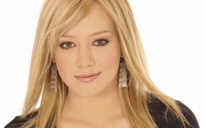 woman with blonde hair and earrings