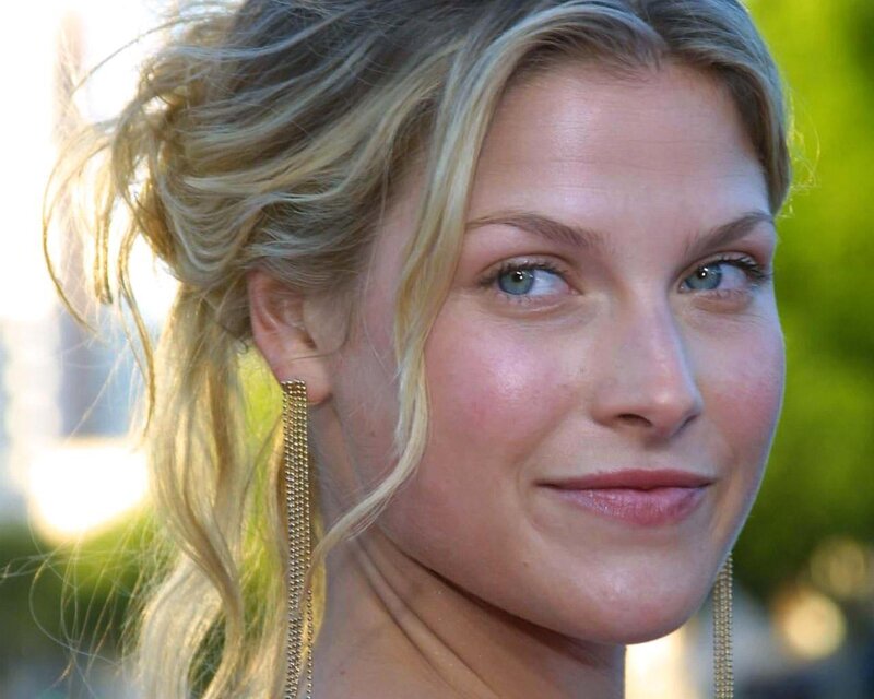 woman with blonde hair and earrings