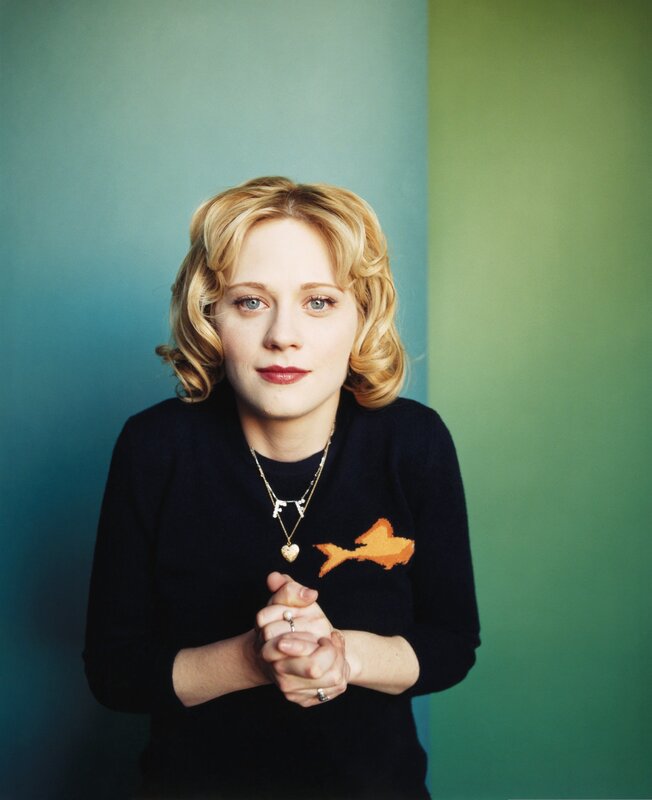 woman with blonde hair and fish sweater