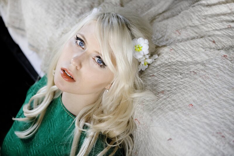 woman with blonde hair and flowers