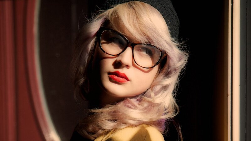 woman with blonde hair and glasses